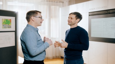 two men talking in office